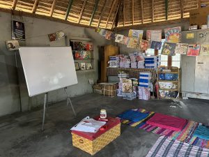 Books on shelves and hanging from cords. Cushions on the floors and a white board. Set in a Dero. The interior of the Samanta Foundation.