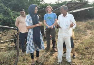 CEE team members and Krishan bhai speaking in the setting of his field.